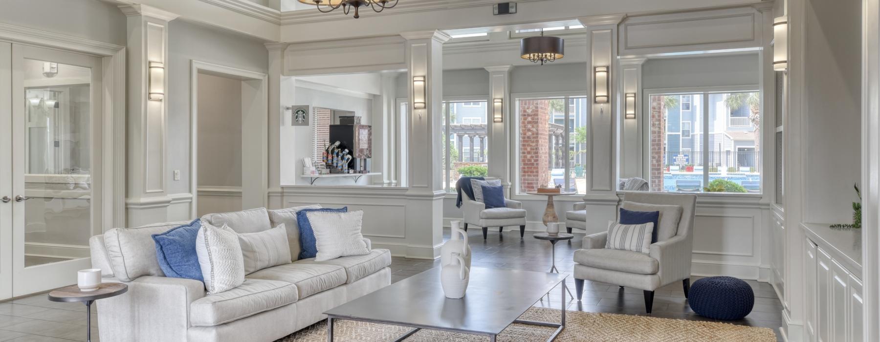 a living room with a large chandelier and a large white couch