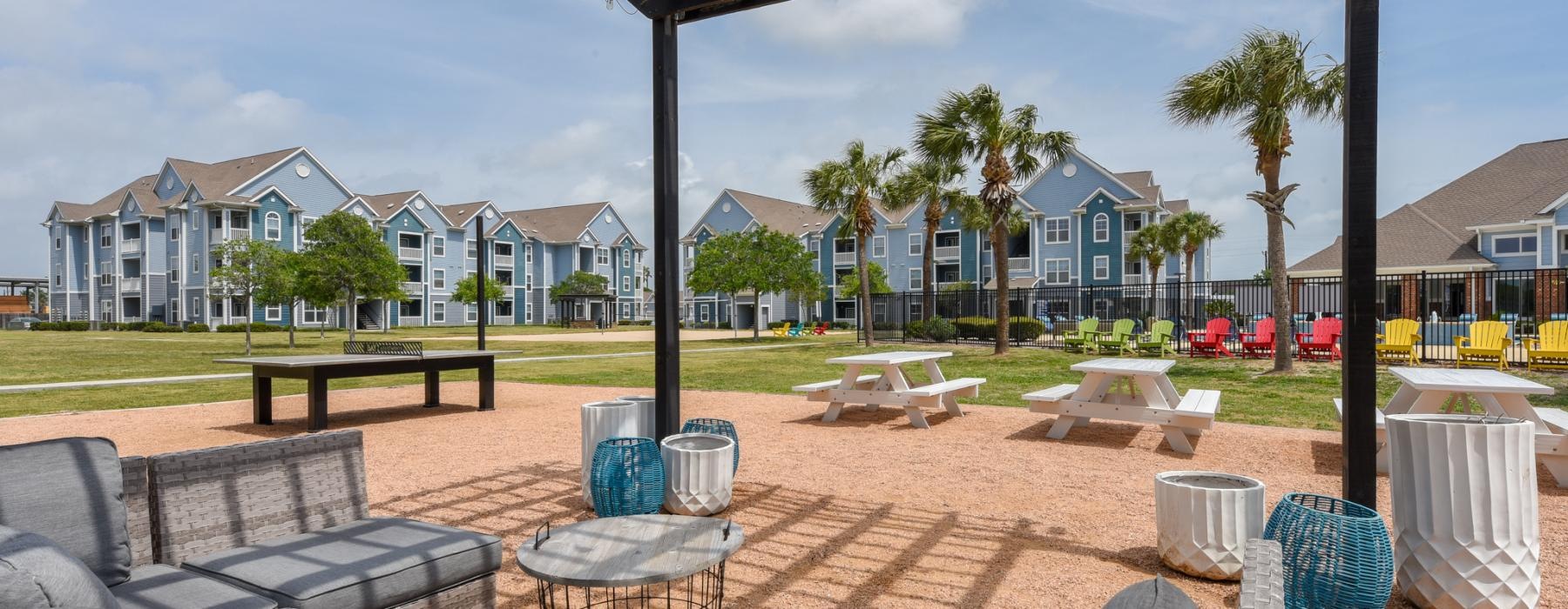 a patio with tables and chairs
